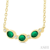 4X3 MM Oval Cut Emerald and 1/50 Ctw Bezel Set Round Cut Diamond Precious Fashion Necklace in 10K Yellow Gold