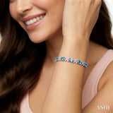 7X5 MM Oval Cut Blue Topaz and 1/10 Ctw Round Cut Diamond Semi-Precious Bracelet in Sterling Silver